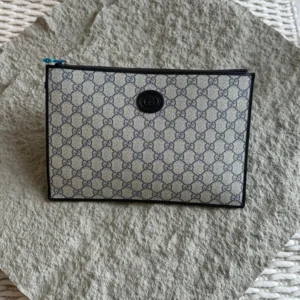 Gucci GG Supreme Pouch Bag – Monogram Crossbody & Clutch | Luxury Essentials
